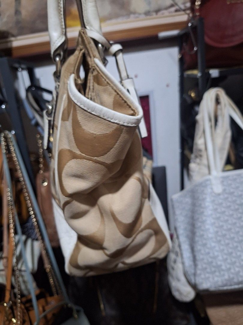 Coach Monogram Canvas Leather Trimmed Handbag (Category: Luxury Bags & Wallets) located in Quezon City. Submitted by cloudymay (Listing ID 1451788457, Image 2). Description: - Authentic Coach monogram canvas handbag - Classic tan and white colorway - Durable leather trim and handles - Stylish tassel details - Interior zippered pocket for essentials - Shows some signs of wear on the leather but still very pretty and clean canvass. - Ideal everyday