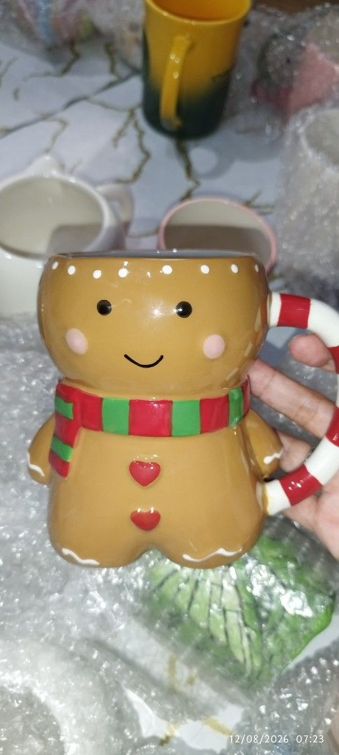 Cute Gingerbread Man Christmas Mug with Candy Cane Handle (Category: Coffee & Tea Tableware) located in Manila. Submitted by silverwhale_cafa21 (Listing ID 1456598919, Image 2). Description: - Adorable gingerbread man design - Fun candy cane handle - Ideal for hot cocoa, coffee, or other holiday drinks - Makes a wonderful gift or festive kitchen addition - Hand wash recommended for longevity - Approximately X inches in height.
