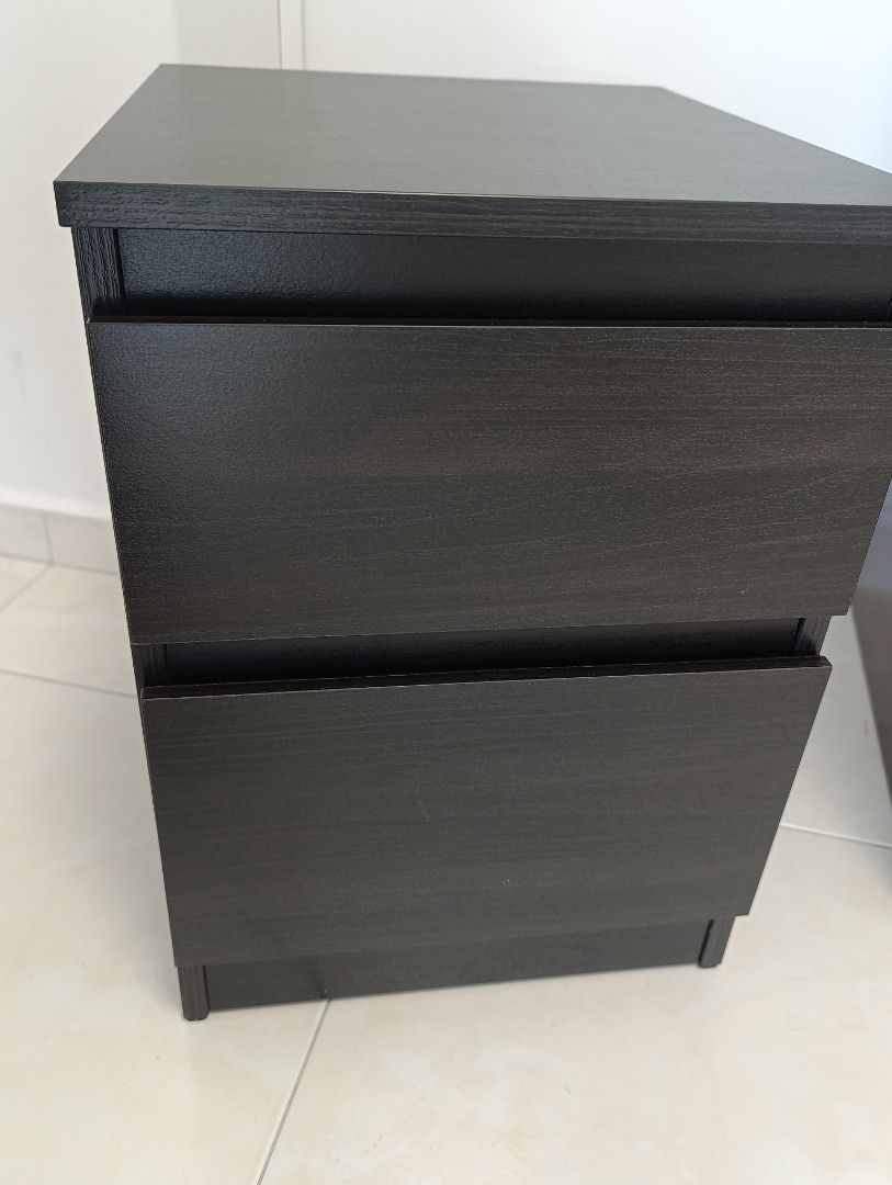 Ikea Bedside Table (Category: Tables & Sets) located in Singapore. Submitted by j2008 (Listing ID 1456449296, Image 2). Description: - Ikea Dark wood nightstand - Two smooth-sliding drawers for storage - Versatile: Ideal for bedroom or beside sofa - Compact size, fits most spaces - Easy to clean surface - Excellent condition .