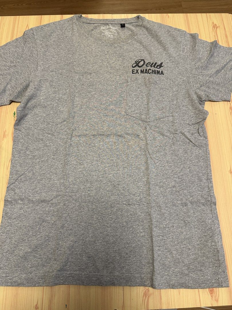 Deus Ex Machina Grey T-Shirt Size M (Category: Tshirts & Polo Shirts ) located in Quezon City. Submitted by mancave_stuff (Listing ID 1456527080, Image 2). Description: - Brand: Deus Ex Machina - Color: Grey - Size: Medium -W20” x L28” - Design: 'The Portal Of Possibilities' graphic on back, small logo on chest pocket - Material: 100% Cotton - Occasion: Casual wear -Used once.