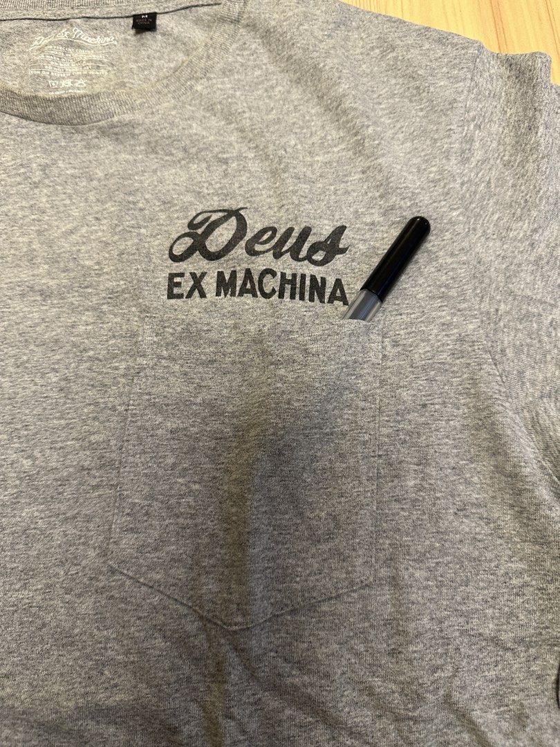 Deus Ex Machina Grey T-Shirt Size M (Category: Tshirts & Polo Shirts ) located in Quezon City. Submitted by mancave_stuff (Listing ID 1456527080, Image 3). Description: - Brand: Deus Ex Machina - Color: Grey - Size: Medium -W20” x L28” - Design: 'The Portal Of Possibilities' graphic on back, small logo on chest pocket - Material: 100% Cotton - Occasion: Casual wear -Used once.