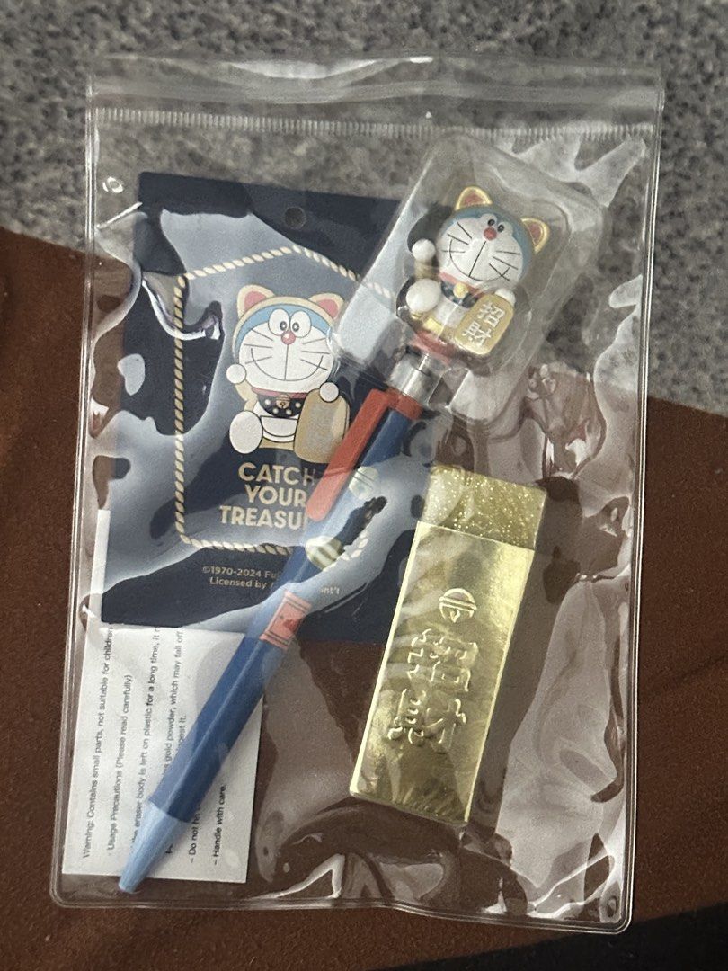 Doraemon "Catch Your Treasure" Mechanical Pen & Gold Eraser Set (Category: Stationery & School Supplies) located in Taguig. Submitted by seek_and_ship (Listing ID 1456478853, Image 1). Description: - Adorable Doraemon pen with a fun charm on top. - Includes a unique gold bar shaped accessory. - "Catch Your Treasure" themed packaging. - Perfect for Doraemon enthusiasts and collectors. - Makes a great, unique gift idea..