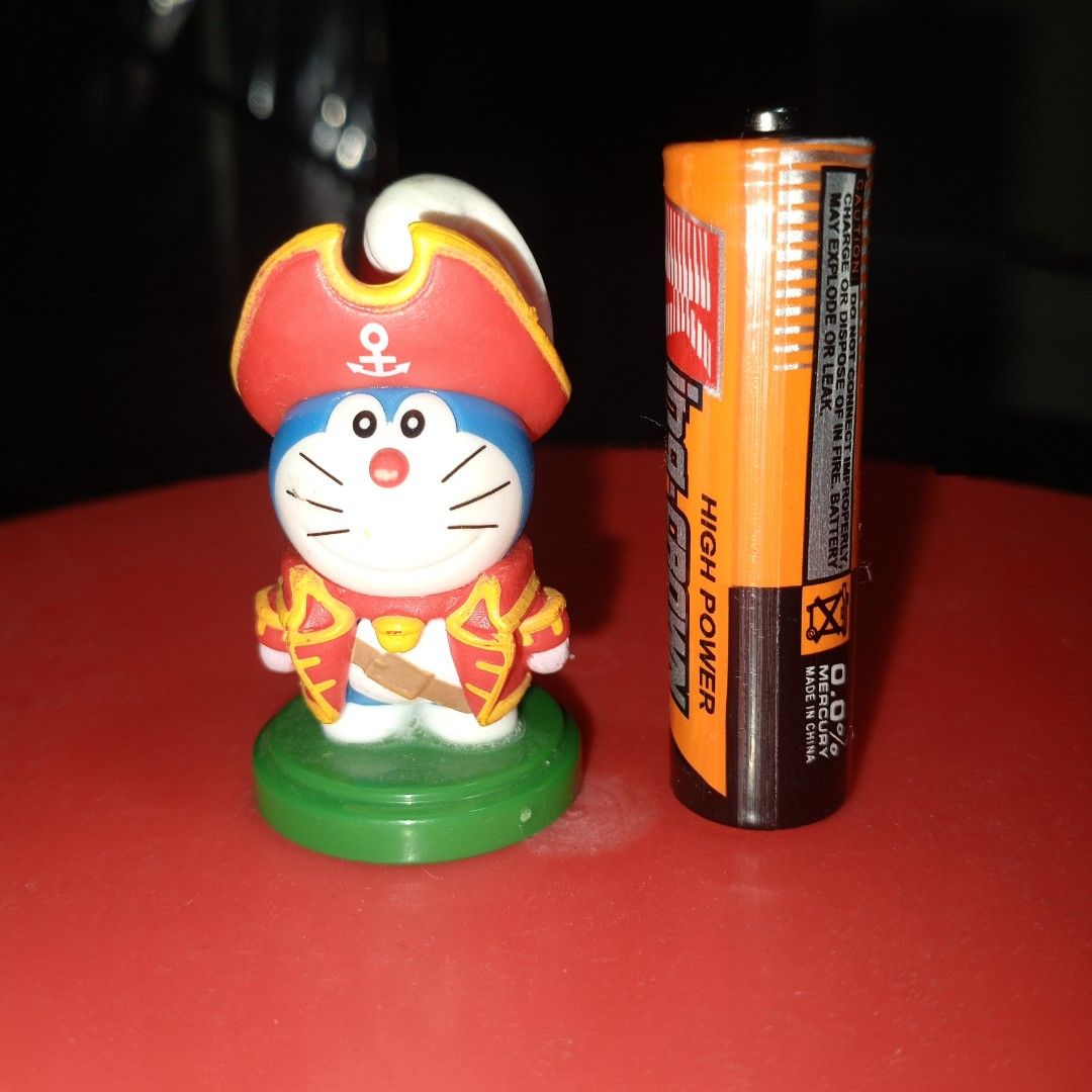 Doraemon Pirate Figure Toy (Category: Figurines & Statues) located in Binan City. Submitted by kaithrifting (Listing ID 1456517689, Image 1). Description: - Adorable Doraemon figure dressed as a pirate. - Comes with a green display base. - Small collectible toy, ideal for fans and collectors. - Perfect for displaying on shelves or desks..