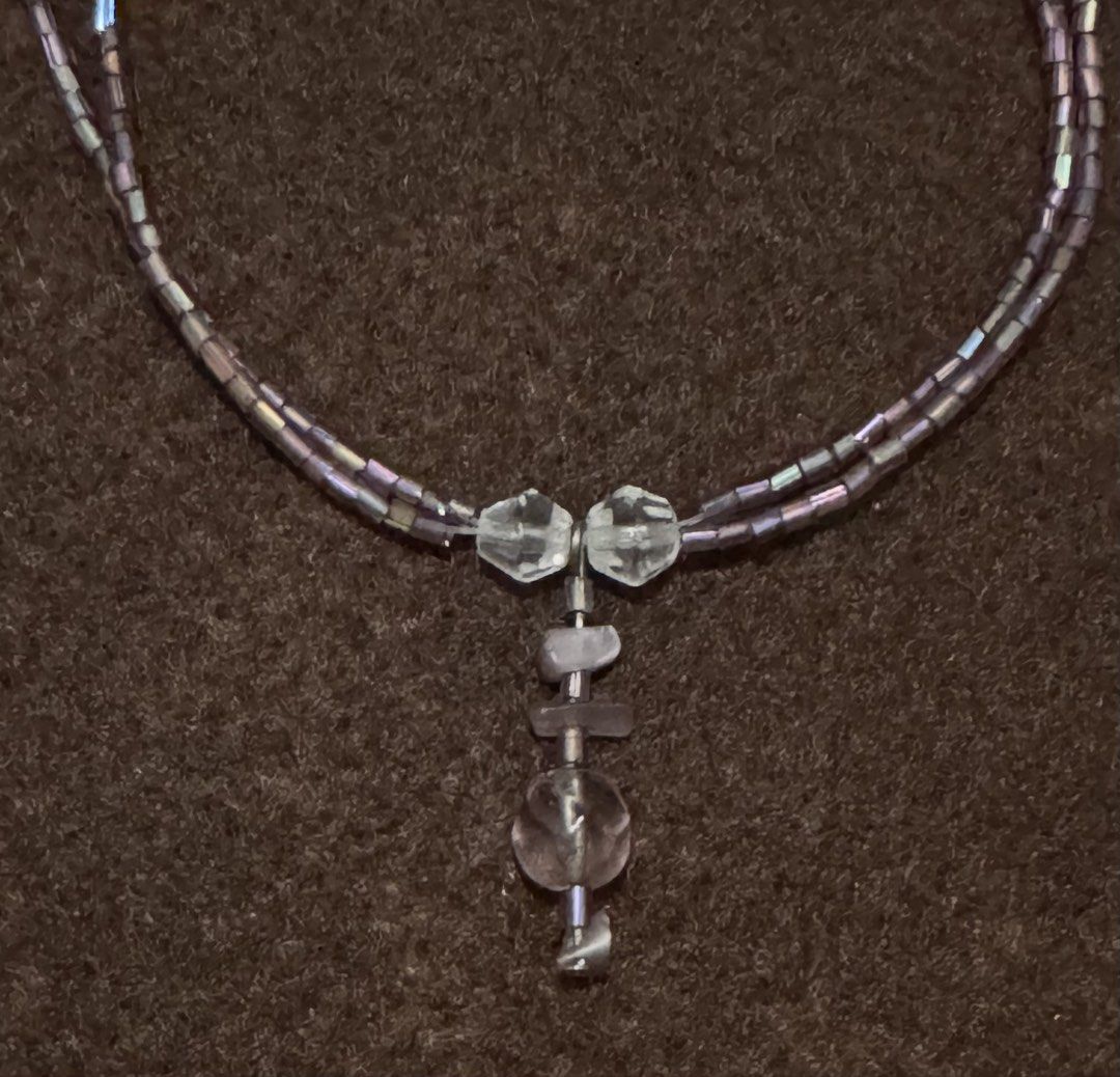 Double Strand Beaded Necklace with Crystal Pendant (Category: Necklaces) located in Quezon City. Submitted by kcapi (Listing ID 1456558531, Image 2). Description: - Double strand necklace - Made with small iridescent beads - Pendant features clear and light purple crystal-like stones - Adjustable clasp for a perfect fit - Adds a touch of sparkle to any outfit.