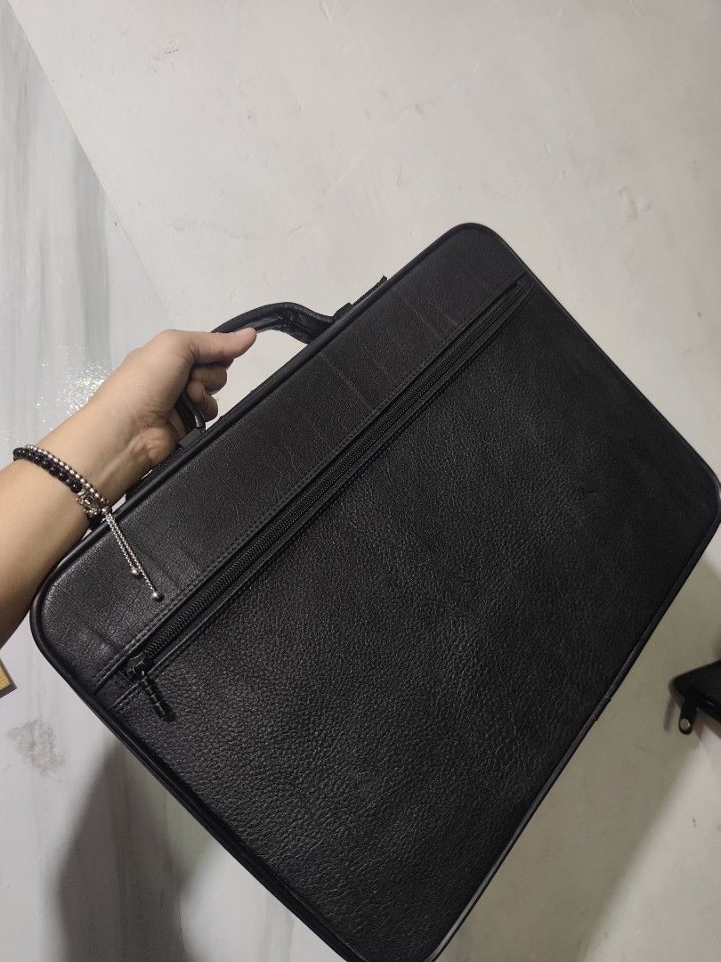 EXACT Black Leather Briefcase Laptop Bag (Category: Briefcases) located in Rizal. Submitted by chicout (Listing ID 1456470497, Image 3). Description: - Textured leather black briefcase - Main zippered compartment - Smaller zippered pocket on the front - Sturdy handle for comfortable carrying - Protective studs on the bottom - Clean and professional design - Ideal for documents or a laptop or as a suitcase for clothes - with key sya kasi pwede ilo