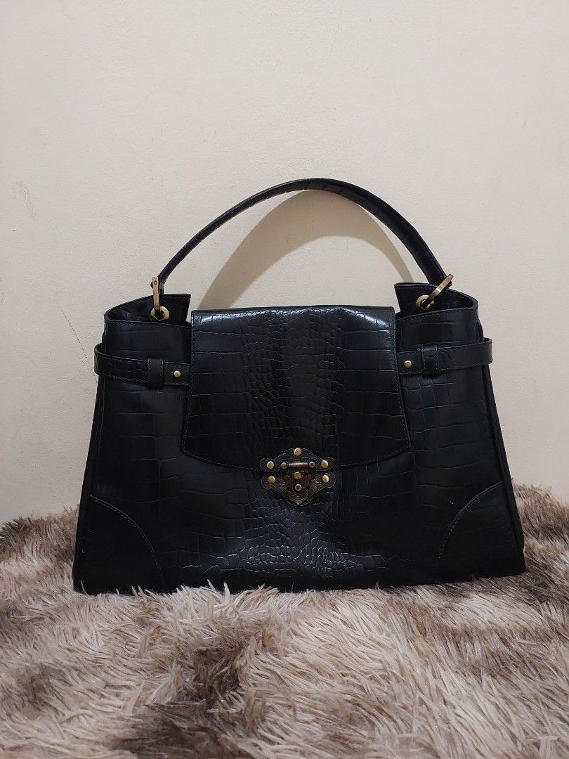 FINO LEATHERWARE Black Croc Embossed Handbag (Category: Luxury Bags & Wallets) located in Malabon City. Submitted by jullie_bag_shop (Listing ID 1456514539, Image 1). Description: - Stylish black handbag with luxurious croc-embossed texture. - Secure front flap with clasp closure missing. - Multiple interior compartments for organization. - Includes a convenient zippered pocket. - Eye-catching light blue lining. - Durable handles with elegant gol