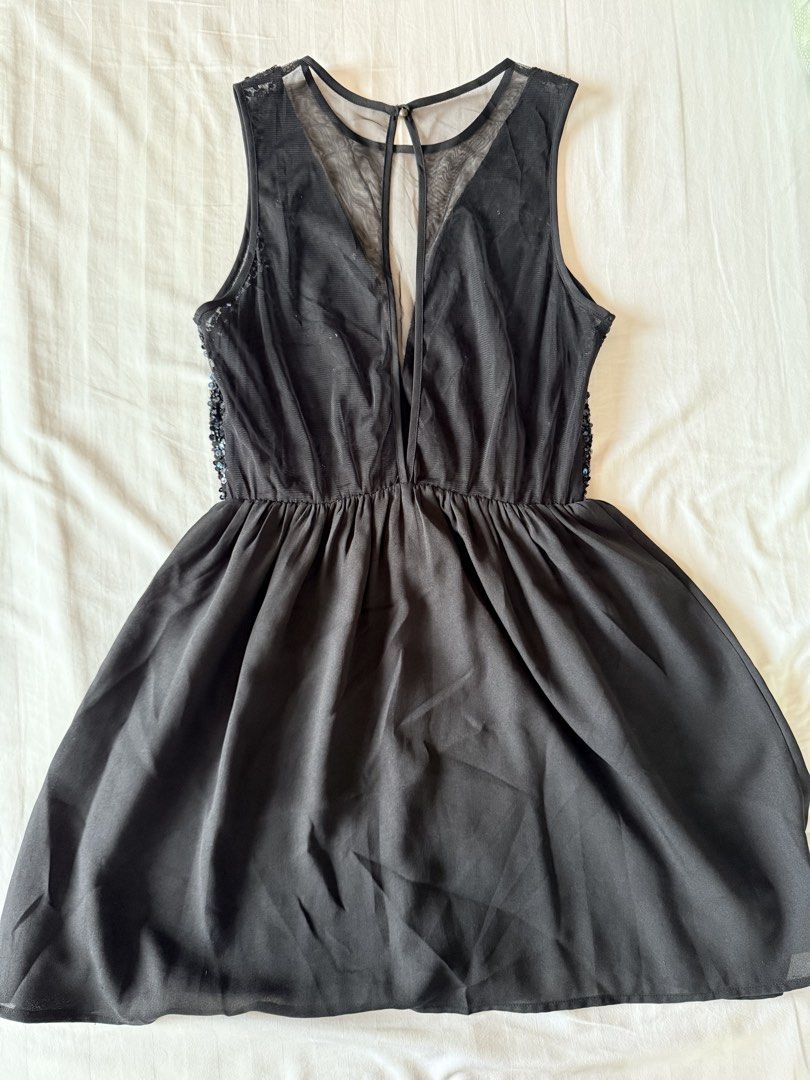Forever 21 Black Sequin Mesh A-line Dress (Category: Dresses) located in Muntinlupa City. Submitted by mmivs (Listing ID 1456474205, Image 3). Description: Brand: Forever 21 Size: US Medium - Plunging sheer illusion neckline - Sparkling sequin embellished bodice (looks midnight blue under certain angles) - Sheer mesh open back - Single button on top back closure - Garterized waist - See last photo for product model pic RFS: decluttering .