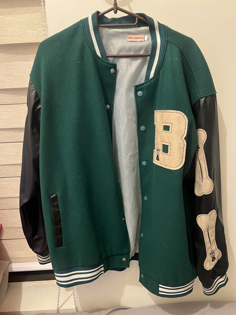 Green & Black Varsity Jacket (Category: Coats, Jackets and Outerwear) located in Las Pinas. Submitted by basicapparel_mnl (Listing ID 1456523692, Image 2). Description: - Cool green varsity jacket - Black sleeves with bone details - 'B' patch on chest - Ribbed cuffs and hem - Snap button closure - Ideal for casual wear.
