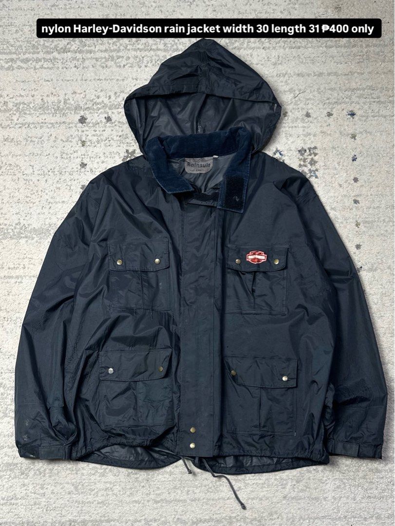 Harley-Davidson Nylon Rain Jacket (Category: Coats, Jackets and Outerwear) located in Daet. Submitted by thrifthings2018 (Listing ID 1456514728, Image 1). Description: - Dark blue Harley-Davidson rain jacket - Made of durable nylon - Features a convenient hood - Multiple pockets for storage - Adjustable drawstring at the waist - Measurements: Width 30, Length 31 - Ideal for rainy weather and motorcycle rides.