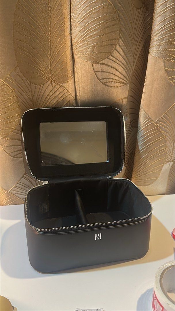 HERA Make up bag (Category: Makeup) located in Malabon City. Submitted by alysaleee (Listing ID 1456577726, Image 2). Description: - Stylish black makeup bag - Convenient mirror inside the lid - Two internal compartments for organized storage - Secure zipper closure - Ideal for travel or everyday use - Keeps your makeup neat and tidy.