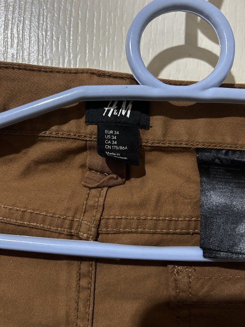 H&M Brown Chinos Pants size 34 US (Category: Chinos) located in Manila. Submitted by dal527 (Listing ID 1456589978, Image 3). Description: - Brand: H&M - Color: Brown - Size: EUR 34 / US 34 - Closure: Button fly - Pockets: Two front, two back - Origin: Made in Bangladesh - Style: Versatile for casual or smart-casual outfits.