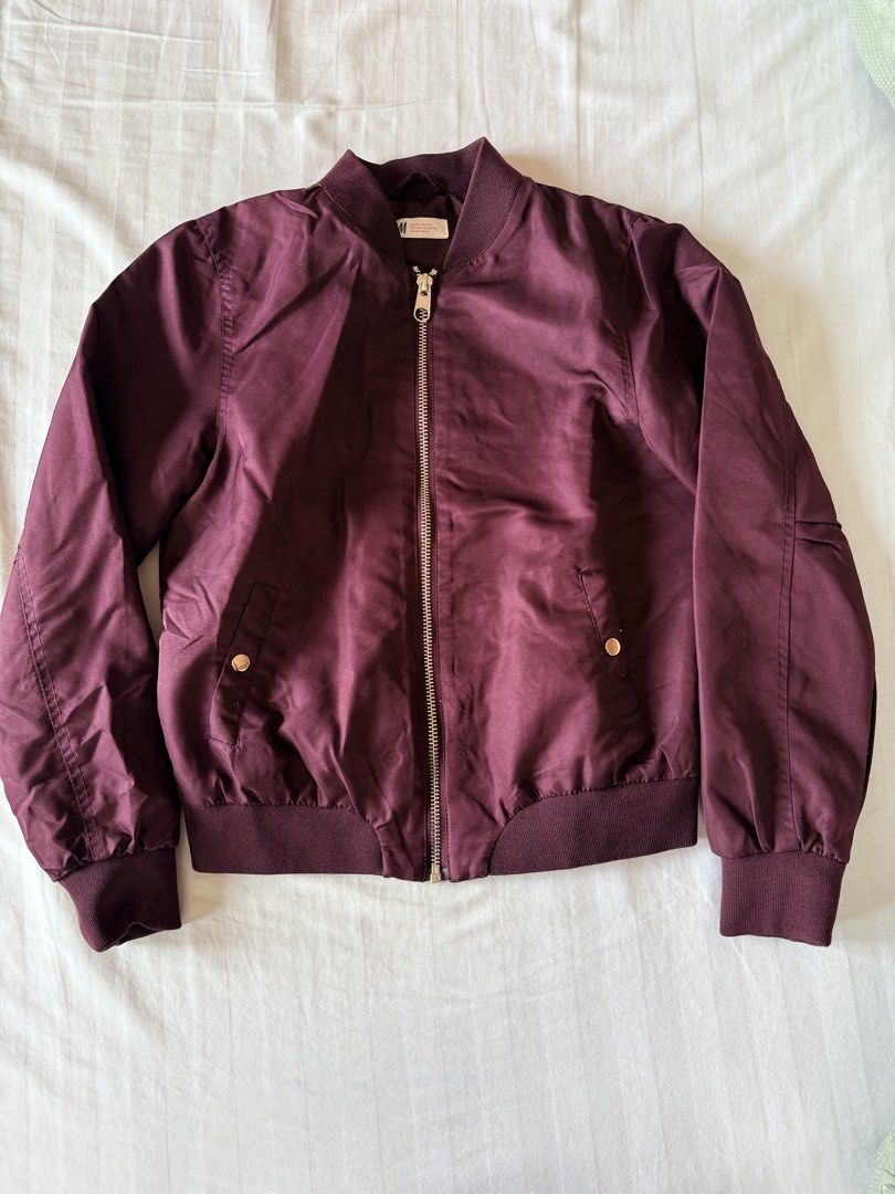 H&M Kids Burgundy Puff Bomber Jacket (Category: Coats, Jackets and Outerwear) located in Muntinlupa City. Submitted by mmivs (Listing ID 1456464868, Image 1). Description: Brand: H&M Kids Size: US 13-14 y/o (can fit up to Size M for women for snug fit) - Burgundy water resistant material - Slight padding in inner lining - Gold zip front closure - Button close side pockets - Garterized collar, waist, and sleeve cuffs - Has some stretch - Can fit S