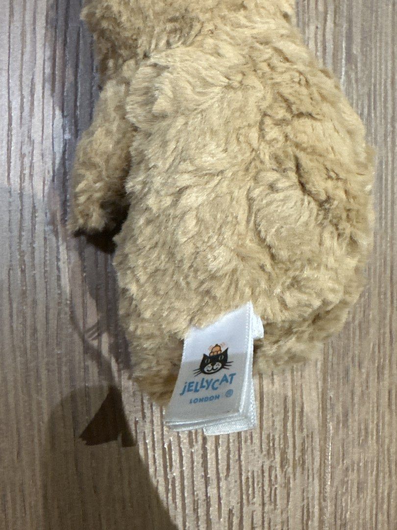Jellycat London Teddy Bear Keychain (Category: Plushies & Soft Toys) located in San Juan City. Submitted by yanna_888 (Listing ID 1456571075, Image 2). Description: - Adorable Jellycat teddy bear design - Made with soft and fluffy material - Features authentic Jellycat London tag - Includes a stylish metal charm - Ideal accessory for bags or keys - Compact and portable size.