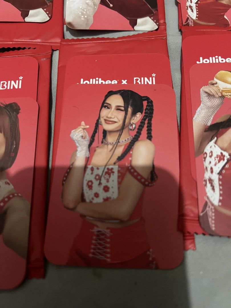 Jollibee X BINI V1 Photocards (Category: Raw Singles) located in Paranaque City. Submitted by ekkostarfall.12902 (Listing ID 1456600643, Image 3). Description: - V1 photocards - opened only - Gwen burger, Colet burger, Sheena burger, Stacy burger, Sheena heart - Each: 150 Take all: 80 MOP: Maya, Bank Transfer SF shouldered by buyer Parañaque.