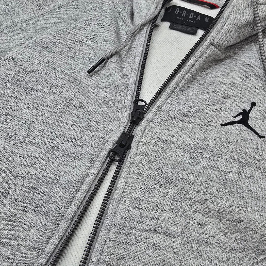 Jordan Grey Zip-Up Hoodie Size L (Category: Coats, Jackets and Outerwear) located in Abucay. Submitted by pickd.pn (Listing ID 1456496143, Image 2). Description: - Grey Jordan zip-up hoodie - Thick cotton - Very Good Condition. Need wash lang - Large on tag.