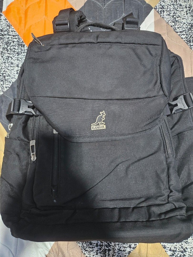 Kangol Black Backpack Bag (Category: Backpacks) located in Manila. Submitted by mistyricst08057 (Listing ID 1456524216, Image 1). Description: - Brand: Kangol - Color: Black - Features: Multiple compartments and pockets for organization - Comfort: Adjustable padded shoulder straps - Durability: Made with durable material - Ideal for: School or everyday use - Condition: Zippers and buckles are in good working order.
