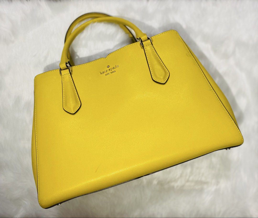 Kate Spade Yellow Leather Tote Handbag (Category: Luxury Bags & Wallets) located in Quezon City. Submitted by raissa.camille (Listing ID 1456551552, Image 1). Description: - Genuine yellow Kate Spade leather tote bag - Secure zip closure for the main compartment - Multiple interior sections for organization - Comfortable top handles for easy carrying - Elegant gold hardware details - Ideal for everyday use and errands.