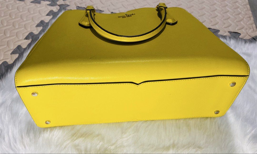 Kate Spade Yellow Leather Tote Handbag (Category: Luxury Bags & Wallets) located in Quezon City. Submitted by raissa.camille (Listing ID 1456551552, Image 3). Description: - Genuine yellow Kate Spade leather tote bag - Secure zip closure for the main compartment - Multiple interior sections for organization - Comfortable top handles for easy carrying - Elegant gold hardware details - Ideal for everyday use and errands.