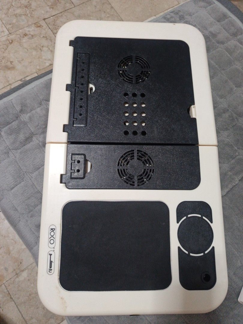 Laptop Desk Cooler (Category: Laptops & Notebooks) located in Manila. Submitted by zedddyxo (Listing ID 1456488283, Image 2). Description: - Brand: Roco - Type: Laptop Desk Cooler - Features: Dual built-in cooling fans - Design: Foldable for easy storage and transport - Built in mousepad - Adjustable legs for height - Functionality: Helps prevent laptop overheating - Condition: Used, good working condition - Meetup Location: Las Piñas City.