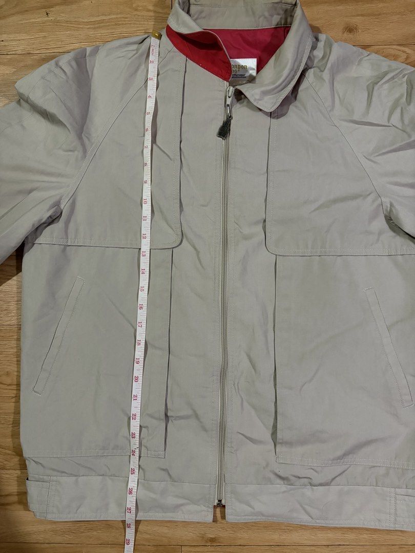 London Fog Beige Harrington Jacket (Category: Coats, Jackets and Outerwear) located in Paranaque City. Submitted by uw4kk (Listing ID 1456556574, Image 2). Description: - Missing clip and it has a minor flaw on the neck - Classic London Fog jacket - Beige color with red lining - Zip-up front - Two front pockets - Size: 44 REG - Made in Taiwan - Ideal for cooler weather.