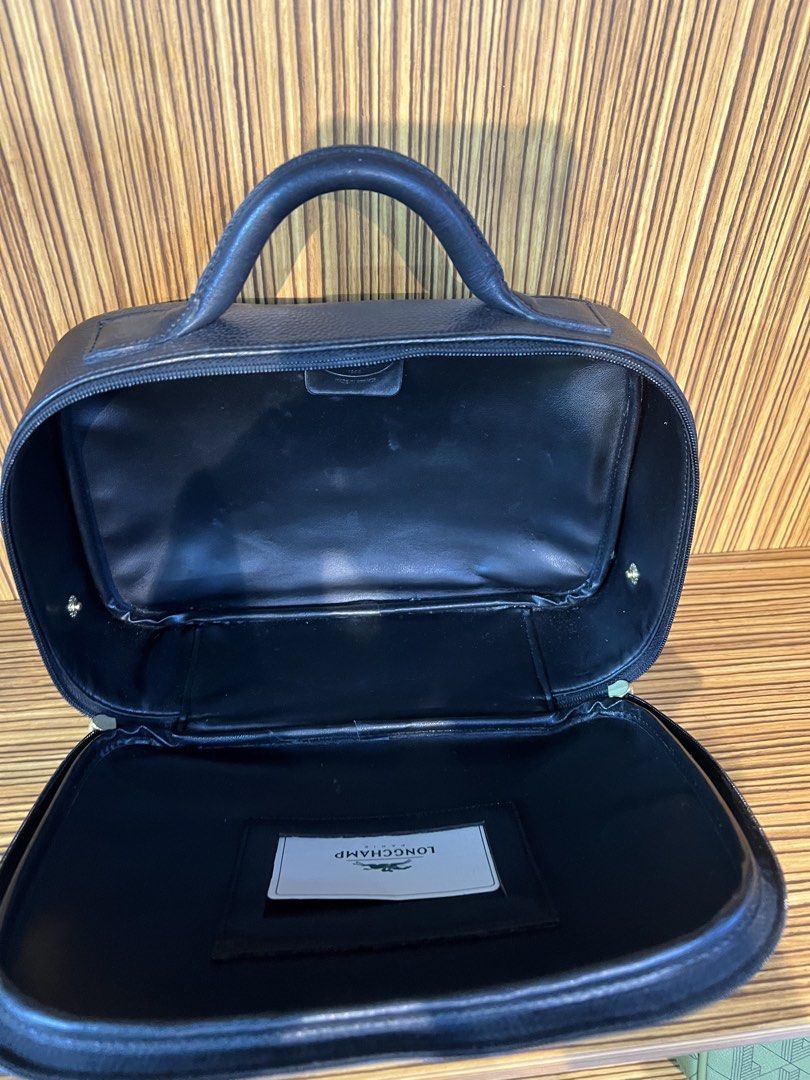 Longchamp vanity (Category: Luxury Bags & Wallets) located in Quezon City. Submitted by brand.selection (Listing ID 1456536235, Image 3). Description: The item in the selected region is a vintage Longchamp vanity case made of black pebbled leather.Key FeaturesMaterial: Premium black pebbled leather (often part of the signature Le Foulonné line).Details: Features a sturdy top handle, dual gold-tone zippers, and the iconic embossed Longchamp gallop