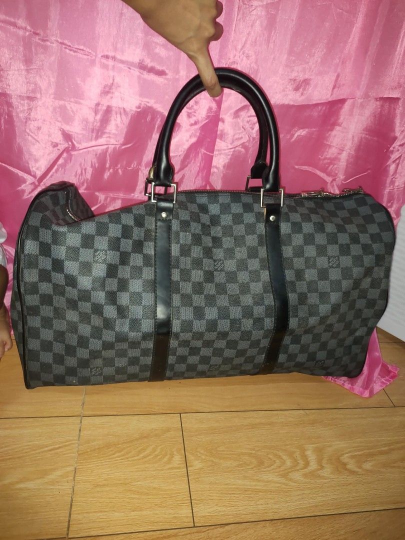 Louis Vuitton Damier Graphite Keepall Duffle Bag (Category: Luxury Bags & Wallets) located in Baguio. Submitted by ownedshopps (Listing ID 1456540473, Image 1). Description: - Classic Louis Vuitton duffle bag - Iconic Damier Graphite pattern - Ideal for travel or weekend trips - Spacious interior for all your essentials - Genuine leather handles and trim - Secure zipper closure - A timeless and stylish addition to your collection.