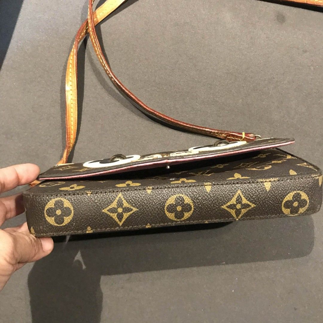 Louis Vuitton Monogram Mini Pochette Accessoire Piggy Face (Category: Luxury Bags & Wallets) located in Midsayap. Submitted by purse_gedo (Listing ID 1456599026, Image 3). Description: - Cute Louis Vuitton crossbody bag - Monogram canvas with playful piggy face design - Pink interior - Adjustable leather strap - Ideal for essentials - Shows some wear on strap and corners - Perfect for a fun, playful look.