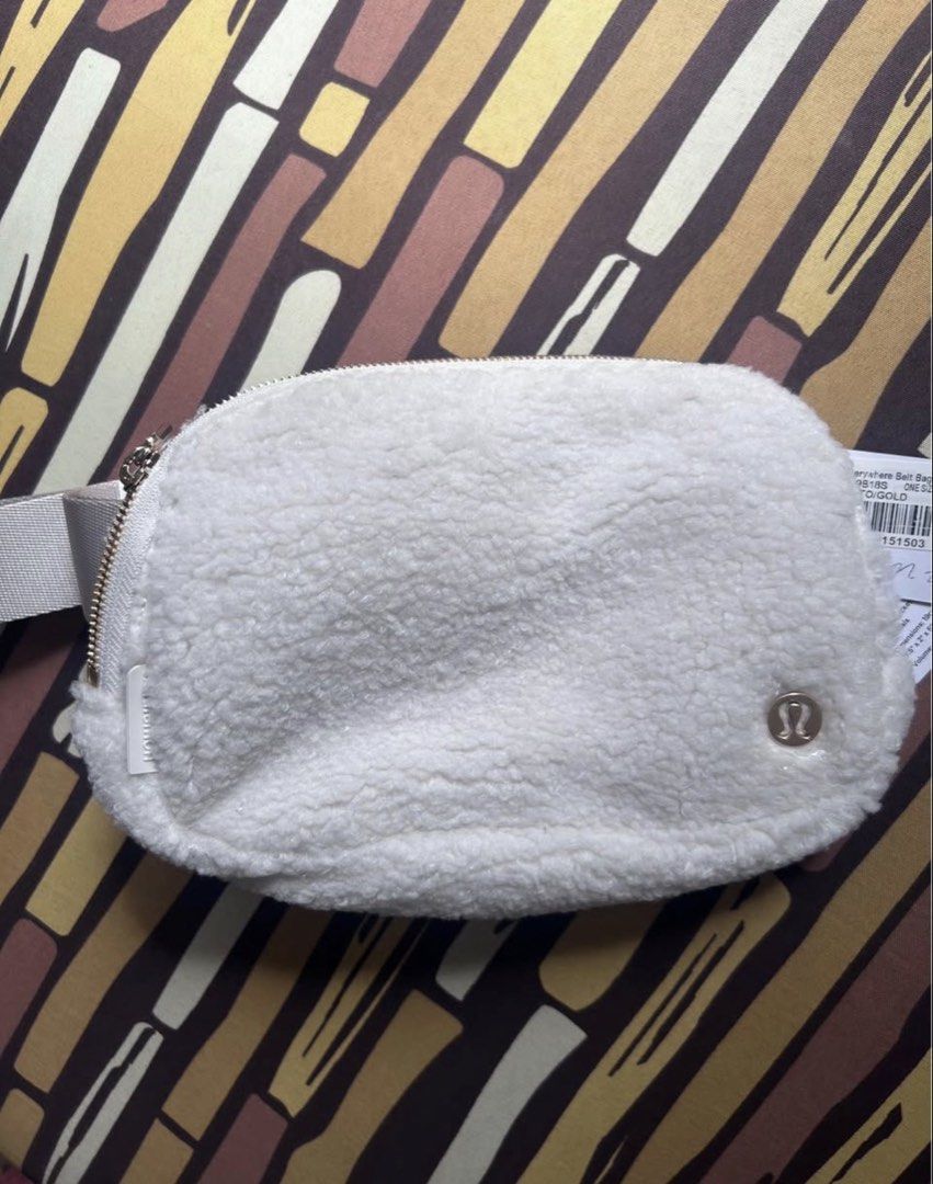 Lululemon Everywhere Belt Bag 1L Light Ivory (Category: Cross-body Bags) located in San Marcelino. Submitted by sainthustle (Listing ID 1456498071, Image 2). Description: - Super cute Lululemon Everywhere Belt Bag - Sherpa fleece material - Color: White - Main zippered compartment - Interior mesh pocket - Adjustable strap - Ideal for everyday use or travel.