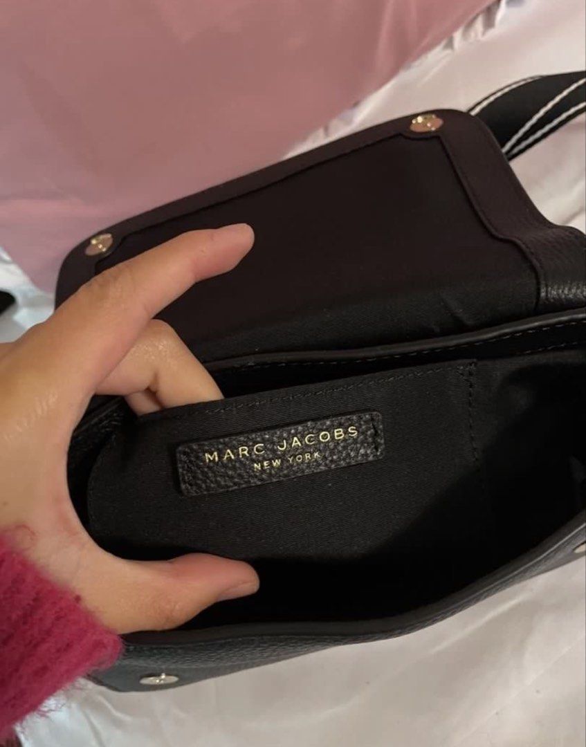 Marc Jacobs Black Leather Crossbody Bag (Category: Luxury Bags & Wallets) located in Baguio. Submitted by dutefinds (Listing ID 1456463075, Image 2). Description: - Brand: Marc Jacobs - Material: Black pebbled leather - Hardware: Gold-tone - Strap: Adjustable with logo detail - Interior: 1 zip pocket, 1 slip pocket - Condition: Comes with tags - Ideal for: Everyday use.