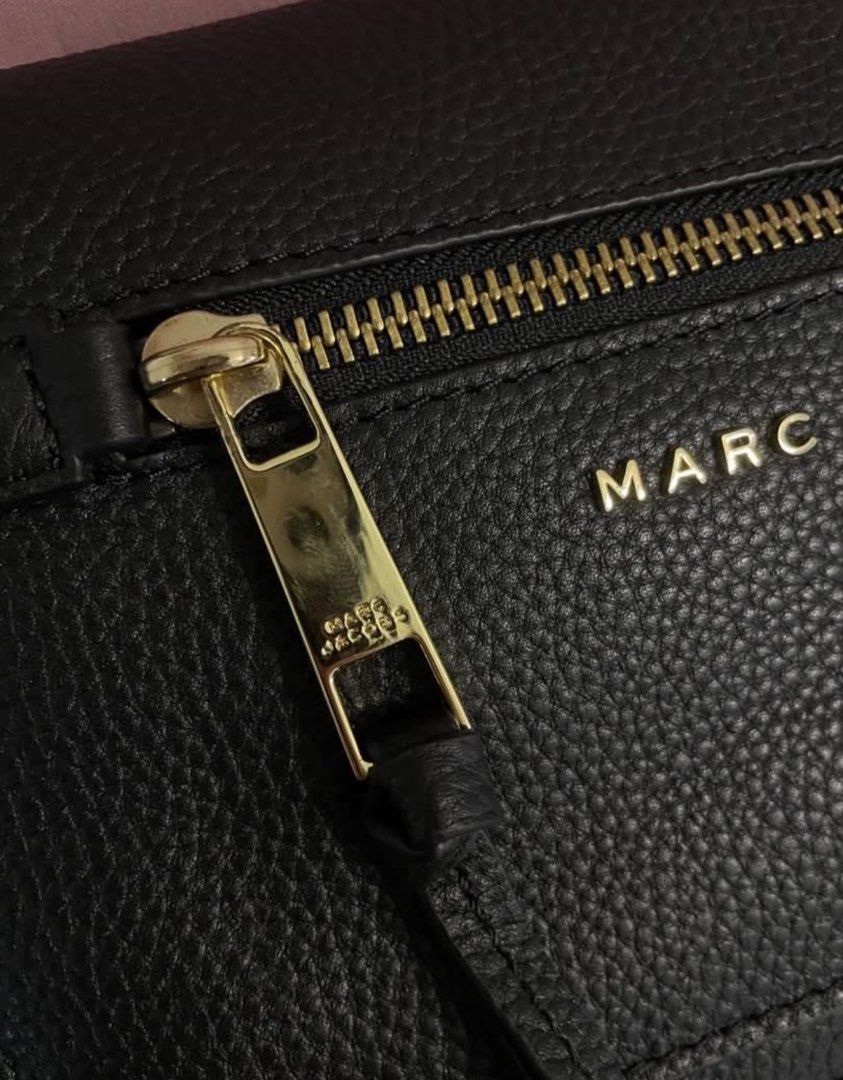 Marc Jacobs Black Leather Crossbody Bag (Category: Luxury Bags & Wallets) located in Baguio. Submitted by dutefinds (Listing ID 1456463075, Image 3). Description: - Brand: Marc Jacobs - Material: Black pebbled leather - Hardware: Gold-tone - Strap: Adjustable with logo detail - Interior: 1 zip pocket, 1 slip pocket - Condition: Comes with tags - Ideal for: Everyday use.
