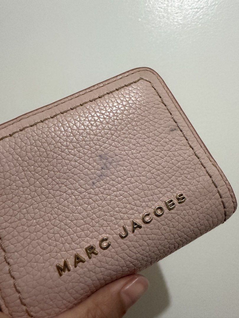Marc Jacobs Pink Leather Bi-Fold Wallet (Category: Luxury Bags & Wallets) located in Quezon City. Submitted by fanchangyuu (Listing ID 1456426206, Image 2). Description: - Brand: Marc Jacobs - Material: Pink pebbled leather - Hardware: Gold tone with embossed logo - Features: Bi-fold design, interior card slots, snap closure - Condition: Minor marks on exterior leather (please check photos) - Detail: Zipper pull with logo detail Real leather. My 
