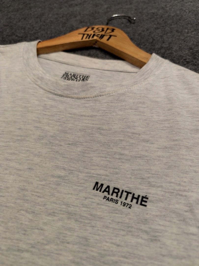 MARITHE FRANCOIS GIRBAUD Paris 1972 Grey T-Shirt Size S (Category: Shirts) located in Cordova. Submitted by bsb.streetluxvintage.clothing (Listing ID 1456573575, Image 2). Description: - Grey Marithe Francois Girbaud T-Shirt - Features 'Marithe Paris 1972' logo on chest - Size: S (Tag) - Measurements: Approx. 18" pit to pit, 25" length - Material: 100% Cotton - Ideal for casual, everyday wear.