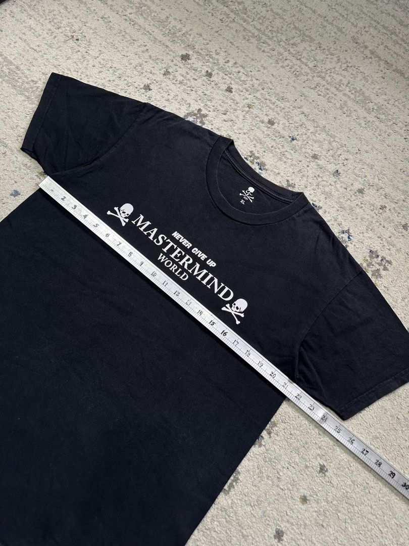 Mastermind World T-Shirt Skull Crossbones Logo Black (Category: Tshirts & Polo Shirts ) located in Daet. Submitted by thrifthings2018 (Listing ID 1456482295, Image 3). Description: - Authentic Mastermind World t-shirt - Features the iconic 'Never Give Up' slogan on the front - Includes skull and crossbones graphics - 'Lazy Boy' text and large skull graphic on the back - Measurements: 21.5 inches width, 28 inches length - Price: P450.