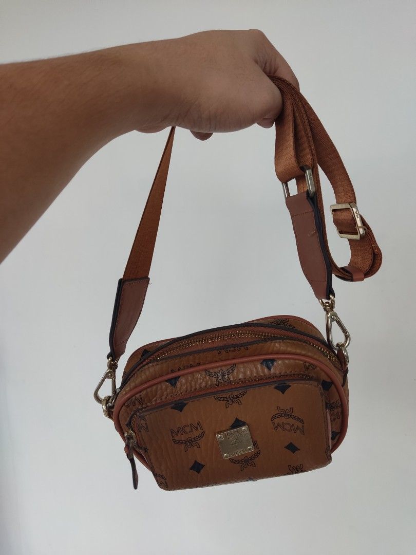 MCM Monogram Crossbody Bag (Category: Luxury Bags & Wallets) located in Pasig City. Submitted by vintage.thrifttph (Listing ID 1456510338, Image 1). Description: - MCM crossbody bag - Signature monogram print - Adjustable strap - Secure zip closure - Small metal logo plate detail - Ideal for carrying essentials on the go.