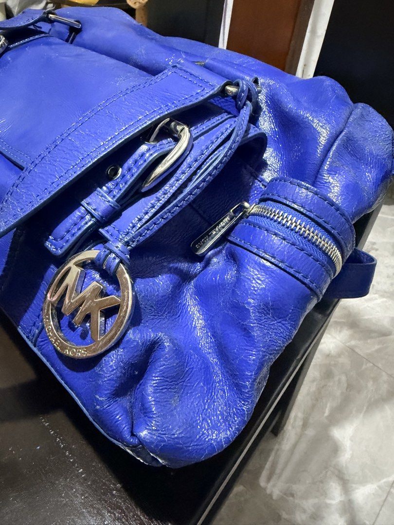 Michael Kors Blue Patent Leather Shoulder Bag (Category: Luxury Bags & Wallets) located in San Juan, Ilocos Sur. Submitted by mklover10 (Listing ID 1456374929, Image 3). Description: - Stunning bright blue Michael Kors shoulder bag - Luxurious patent leather finish - Chic silver hardware details (buckles & zippers) - Iconic MK logo charm included - Ample storage with multiple interior and exterior pockets - Ideal for stylish everyday wear.