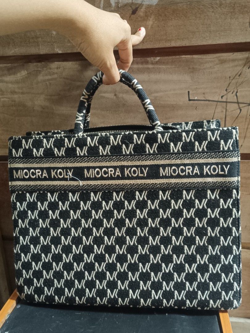 MIOCRA KOLY Tote Bag with CHRISTIAN DIOR Strap (Category: Luxury Bags & Wallets) located in Cebu City. Submitted by elen30abalo (Listing ID 1456425749, Image 1). Description: - Stylish black and white patterned tote bag - 'MIOCRA KOLY' text detail on the exterior - Interior strap with 'CHRISTIAN DIOR' text - Secure zipper closure - Ample space for everyday essentials - Ideal for daily use.