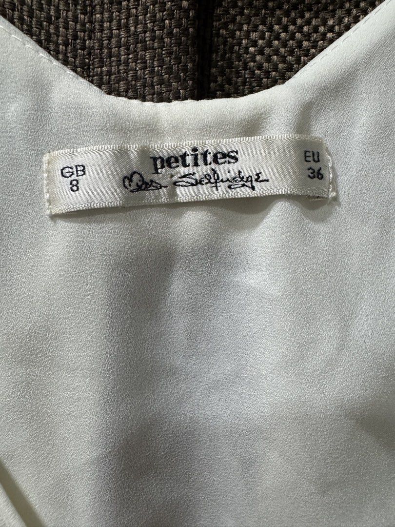 Miss Selfridge Petites White Bow Back Tank Top (Category: Sleeveless) located in Guiguinto. Submitted by thehiddenwardrobe (Listing ID 1456573457, Image 3). Description: - Brand: Miss Selfridge Petites - Color: White - Style: Tank top - Features: Cute bow detail at the back - Neckline: V-neck - Sleeves: Sleeveless - Fabric: Lightweight.