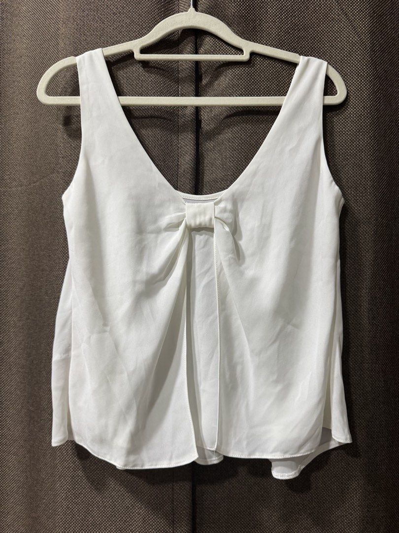 Miss Selfridge Petites White Bow Back Tank Top (Category: Sleeveless) located in Guiguinto. Submitted by thehiddenwardrobe (Listing ID 1456573457, Image 2). Description: - Brand: Miss Selfridge Petites - Color: White - Style: Tank top - Features: Cute bow detail at the back - Neckline: V-neck - Sleeves: Sleeveless - Fabric: Lightweight.