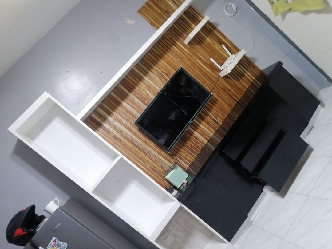 Modern TV Console with Wall Shelving Unit (Category: TV Consoles) located in Rizal. Submitted by rome_25 (Listing ID 1456551937, Image 3). Description: - Sleek TV console with a stylish wooden accent wall panel. - Includes a tall white shelving unit for additional display or storage. - Plenty of storage space with convenient drawers and open shelves. - Perfect for organizing and decluttering your entertainment area. - Dimensions: [insert dimensio