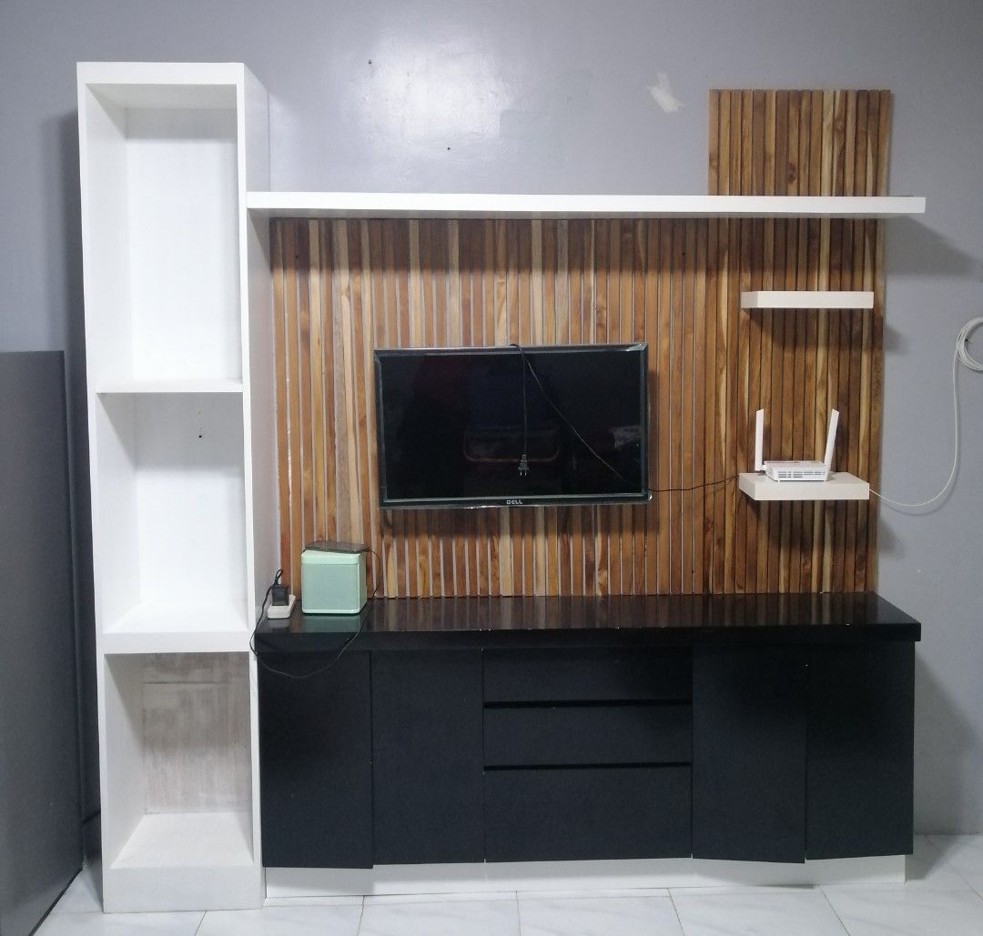 Modern TV Console with Wall Shelving Unit (Category: TV Consoles) located in Rizal. Submitted by rome_25 (Listing ID 1456551937, Image 1). Description: - Sleek TV console with a stylish wooden accent wall panel. - Includes a tall white shelving unit for additional display or storage. - Plenty of storage space with convenient drawers and open shelves. - Perfect for organizing and decluttering your entertainment area. - Dimensions: [insert dimensio
