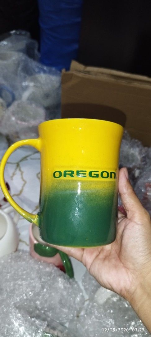 Oregon Ducks Yellow and Green Coffee Mug (Category: Coffee & Tea Tableware) located in Manila. Submitted by silverwhale_cafa21 (Listing ID 1456598826, Image 2). Description: - Official Oregon Ducks logo mug - Vibrant yellow and green color scheme - 'OREGON' text prominently displayed - Features a bright yellow handle for comfortable grip - Perfect for enjoying your morning coffee or tea - A must-have for any dedicated Ducks fan!.