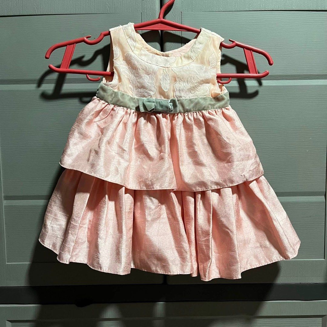 Pink Tiered Dress with Floral Bodice (Category: Dresses) located in Manila. Submitted by solvithrifts (Listing ID 1456571021, Image 1). Description: - Cute pink dress for little girls - Lovely floral pattern on bodice - Tiered skirt with satin-like fabric - Small green ribbon with bow at waist - Ideal for parties and special occasions - Buttons at the back for easy wear.