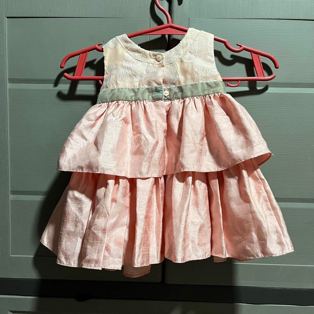 Pink Tiered Dress with Floral Bodice (Category: Dresses) located in Manila. Submitted by solvithrifts (Listing ID 1456571021, Image 2). Description: - Cute pink dress for little girls - Lovely floral pattern on bodice - Tiered skirt with satin-like fabric - Small green ribbon with bow at waist - Ideal for parties and special occasions - Buttons at the back for easy wear.