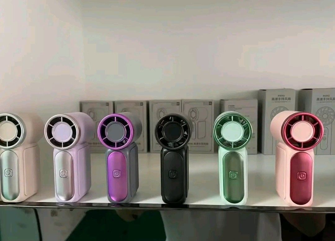 Portable Mini Handheld Fan Rechargeable USB Cooler (Category: Fans) located in Manila. Submitted by marvieobordo (Listing ID 1456497416, Image 2). Description: - Cute and portable mini fans - Rechargeable via USB - Available in pink, purple, green, silver, and orange - Lightweight and easy to carry - Perfect for staying cool on the go, summer days, or stuffy rooms.