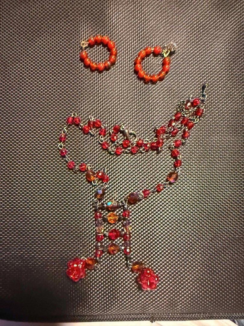 Red Beaded Necklace and Hoop Earrings Set (Category: Necklaces) located in Pasig City. Submitted by xandraaamia (Listing ID 1456498965, Image 1). Description: - Cute red beaded necklace with a chain. - Features a geometric pendant with colorful crystals. - Includes matching hoop earrings with red beads. - Perfect for adding a pop of color to your outfit..