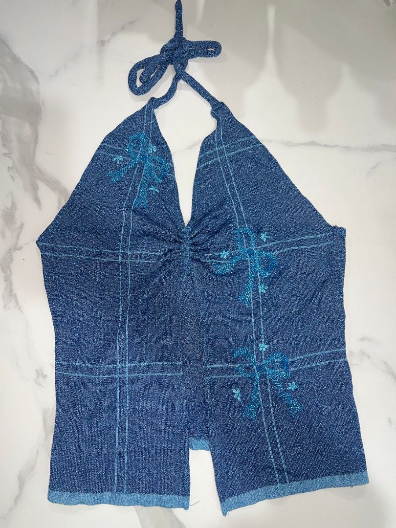 ShopFlorice Remade - Blue Sparkly Ruched Halter Top (Category: Sleeveless) located in Pasig City. Submitted by sqfund (Listing ID 1456567936, Image 3). Description: ✨MY FAVEE✨ so pretty No brand. Purchased from an IG vintage shop (shop.florice) - Blue halter neck remade top - Twist front detail - Subtle patterned fabric - Flowy, open front design - Beaded floral design ____________________________________________________________________ MOP: GCas