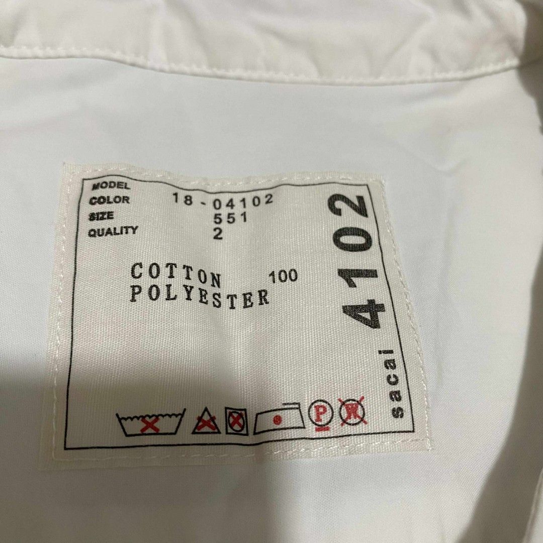 Sacai Shoulder Zip Shirt (Category: Luxury Apparel) located in Abucay. Submitted by esangbalakalang (Listing ID 1456542856, Image 2). Description: Description: - Unique shoulder zip detail - Size 2 - Comfortable cotton and polyester blend - Stylish chest pocket - Side slits with a layered hem for a modern silhouette.