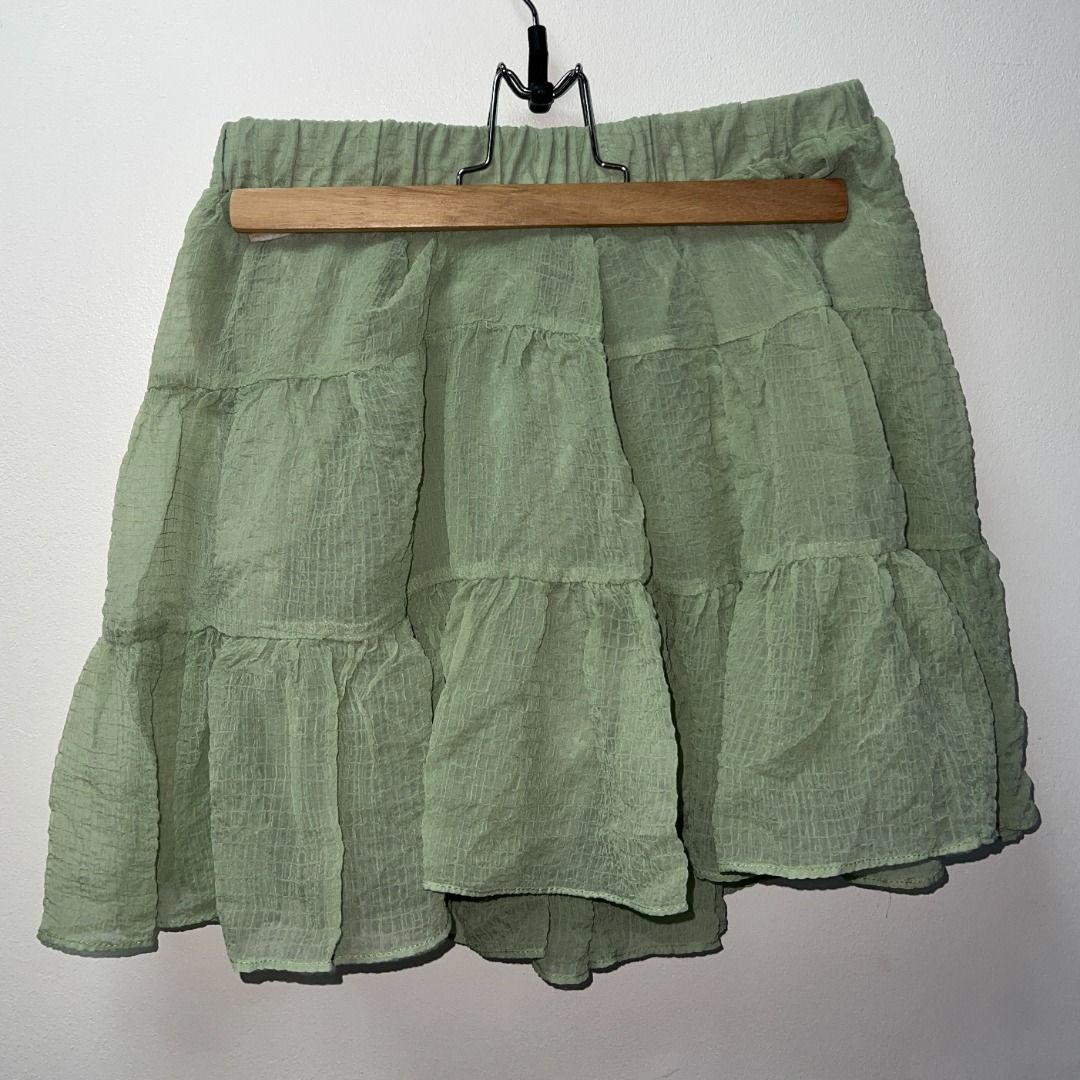 Fairycore Sage Green Tiered Ruffle Mini Skirt (Category: Skirts) located in Pasig City. Submitted by sqfund (Listing ID 1456475676, Image 1). Description: ✨Good condition✨ No brand. Purchased from a live seller - Sage green mini skirt - Tiered ruffle design - Textured crinkle fabric - Comfortable elastic waistband - Fully lined ____________________________________________________________________ MOP: GCash / BDO Open to reasonable offers for bund