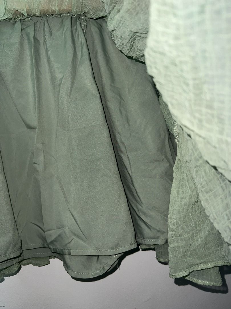 Fairycore Sage Green Tiered Ruffle Mini Skirt (Category: Skirts) located in Pasig City. Submitted by sqfund (Listing ID 1456475676, Image 2). Description: ✨Good condition✨ No brand. Purchased from a live seller - Sage green mini skirt - Tiered ruffle design - Textured crinkle fabric - Comfortable elastic waistband - Fully lined ____________________________________________________________________ MOP: GCash / BDO Open to reasonable offers for bund