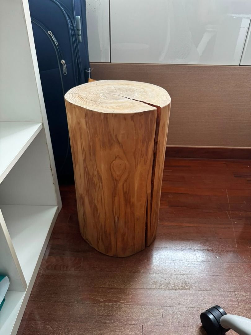 Solid Wood Log Stool / Side Table (Category: Tables & Sets) located in Singapore. Submitted by alinesardi12183 (Listing ID 1456528276, Image 2). Description: - Unique solid wood stool - Features natural wood grain and texture - Versatile: use as a side table or extra seating - Adds a rustic touch to any home decor - Dimensions: Approximately 18 inches tall, 14 inches in diameter - Note: Some natural cracks present on the top surface.
